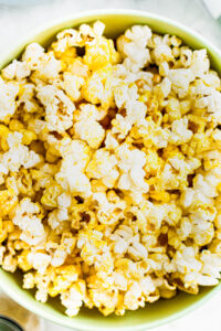 Close up overhead photo of a bowl of vegan buttered popcorn