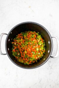 Overhead photo of a large pot with sauteeing veggies