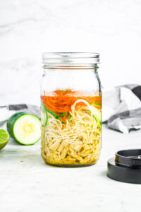 Head on photo of a sealed mason jar with homemade ramen in it
