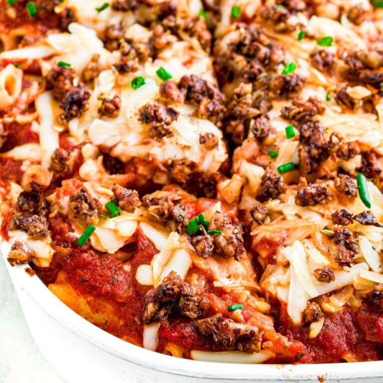 Overhead close up view of a square white baking dish filled with vegan baked ziti