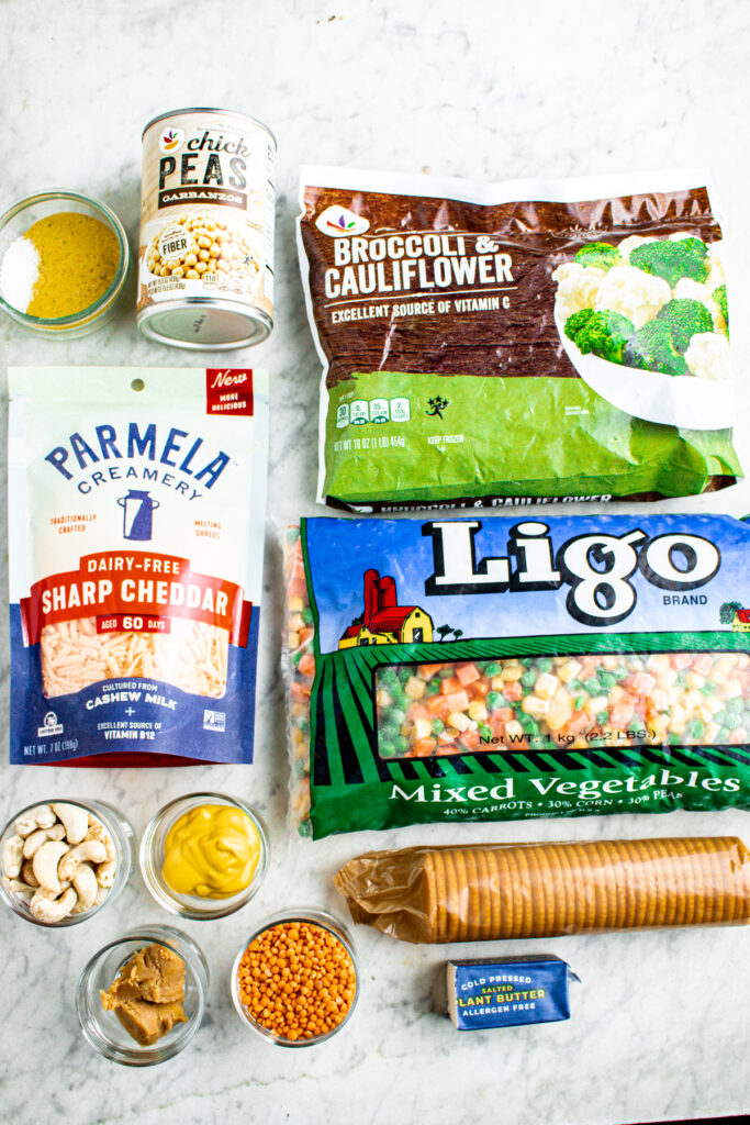 Overhead view of all the ingredients you need to make veggie casserole on a grey marble countertop