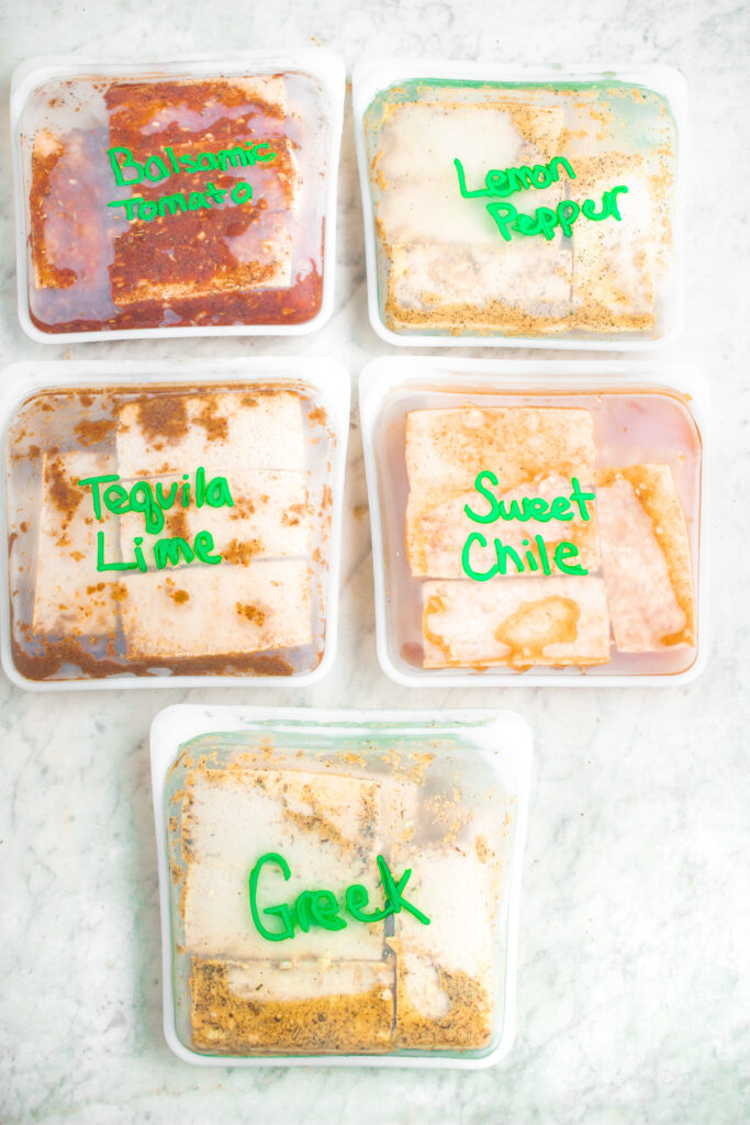 5 silicone bags filled with marinated tofu, each labeled with the type of marinade