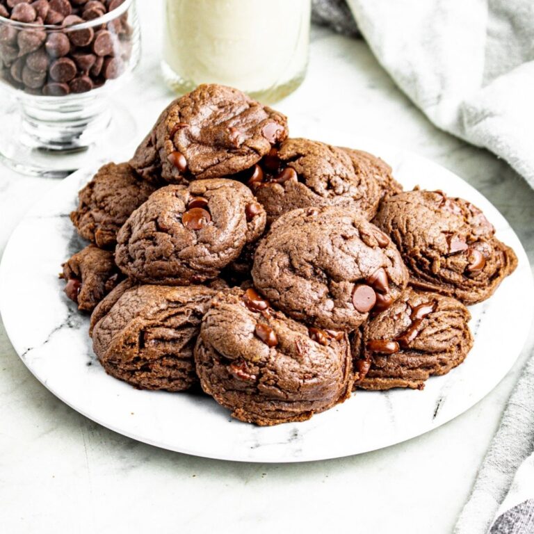 Head on view of a pile of vegan chocolate cookies made with cake mix on a round grey marble plate
